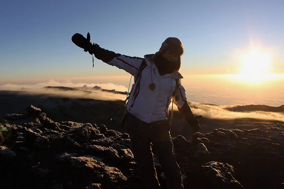 Kilimanjaro summit at sunrise during clear dry season with Uhuru Peak sign visible