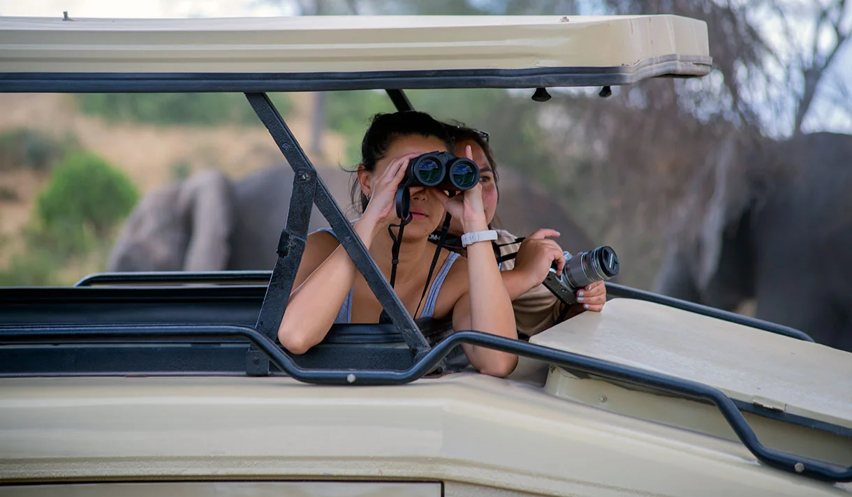 Safari vehicle driving through the savannah in Tanzania